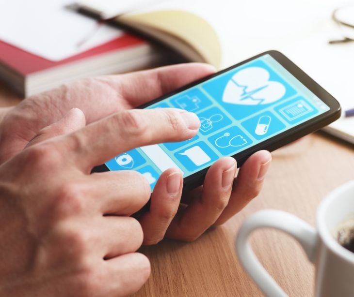 hands holding smartphone with medical icons