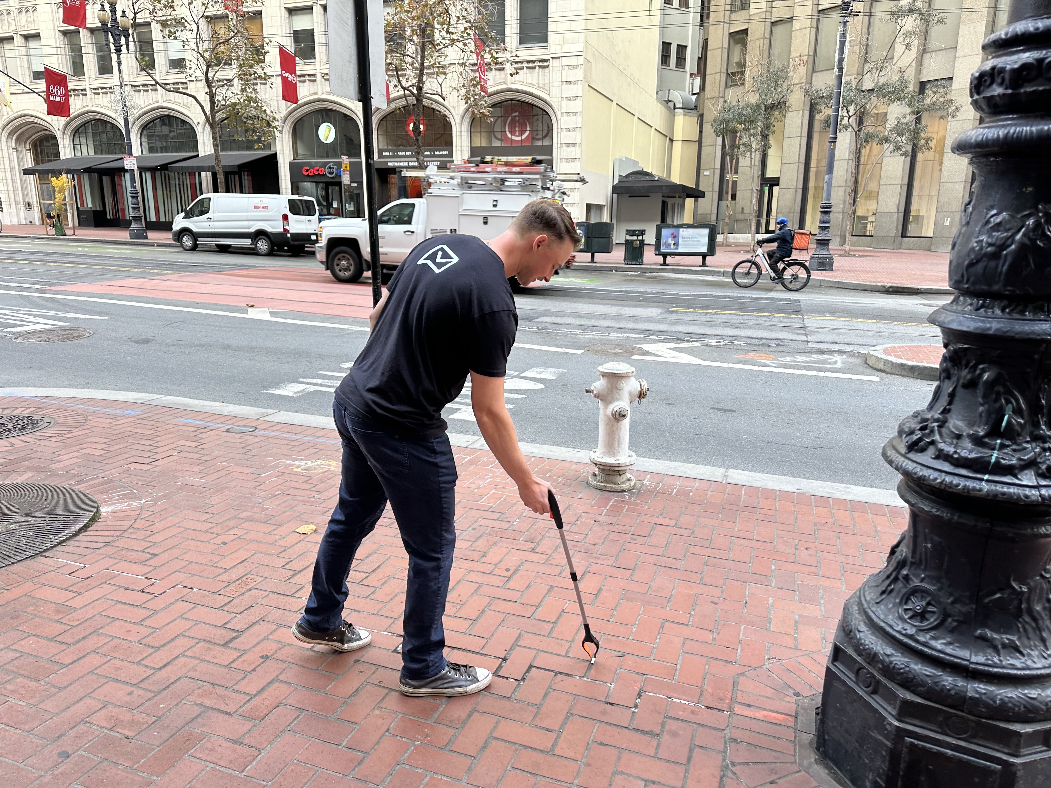 Evan Fitzgerald (VP Finance) applying fine motor skils to a cigarette butt on Market Street