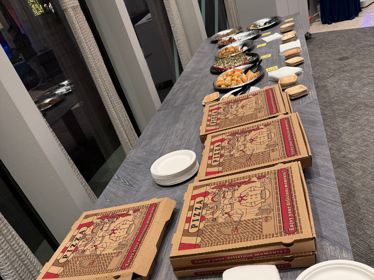 It wouldn't be a tech party without stacked pizza boxes | 500 Global's Holiday Party 2025