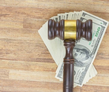 legal gavel over stack of money