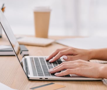 female hands on laptop