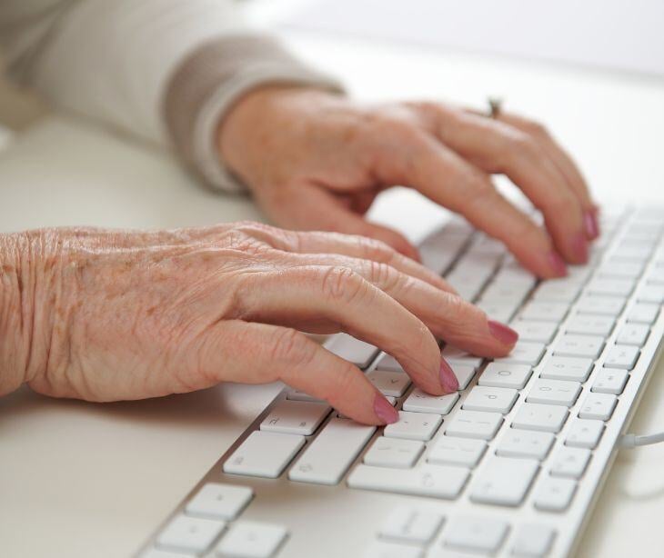 elderly hands on computer
