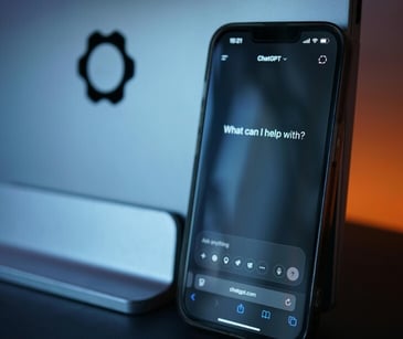 Image of a phone with an AI chatbox open. 