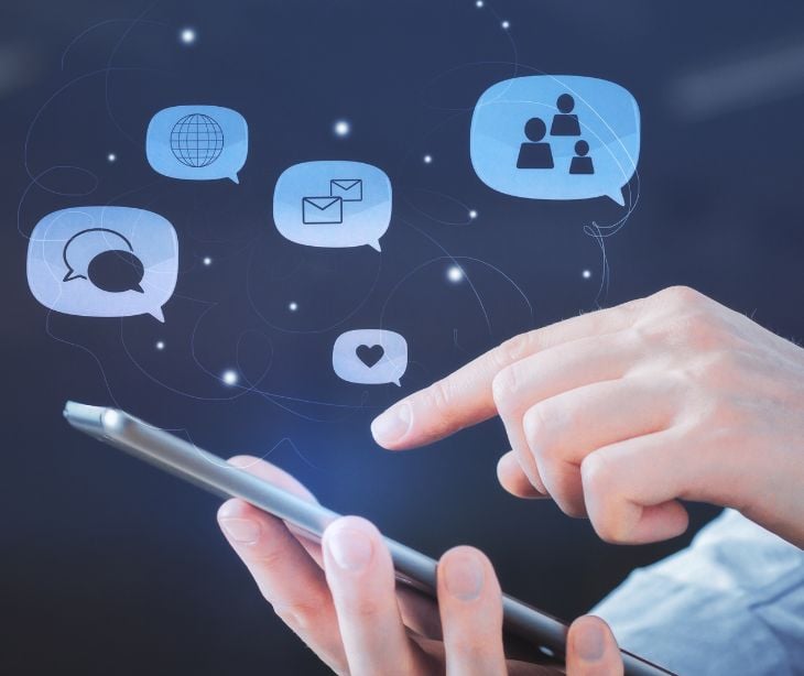 phone and hand with floating digital icons