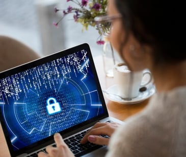 Image of someone looking at a computer screen with a lock on it. 