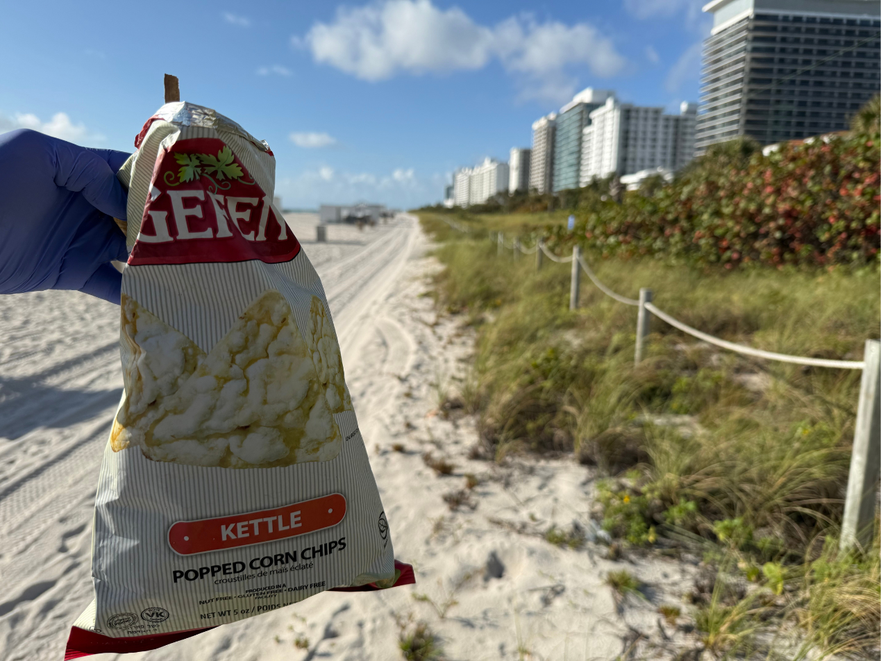 Hoala Greevy found an empty bag of chips on the beach, caught in the brush by onshore winds.