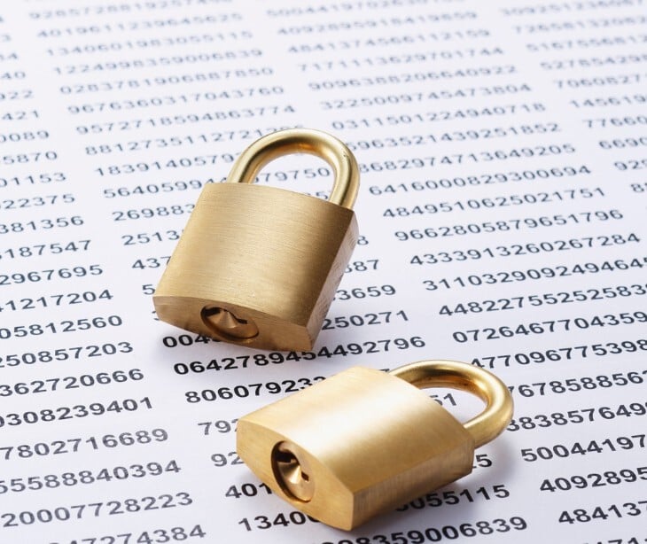 Image of a lock over code typed on paper. 