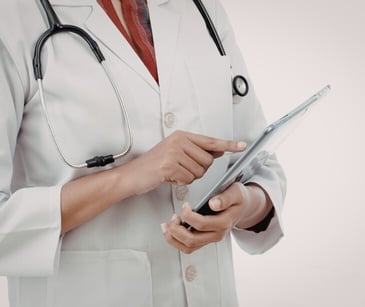 Image of a practicioner holding a tablet. 