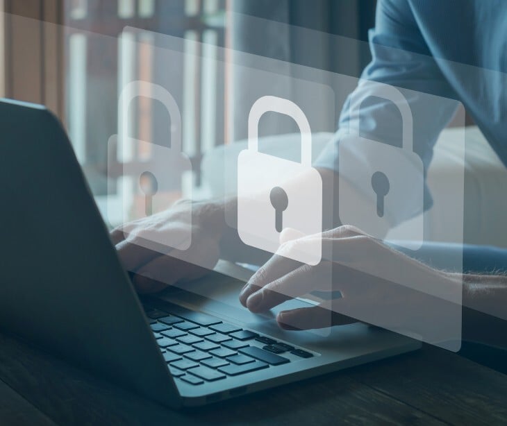 Image of someone on a computer with a lock over it. 