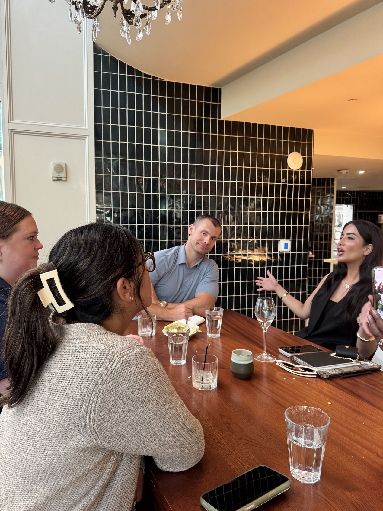 Guests in conversation around the table at St. Cecilia in Atlanta | The Paubox Table: September dinner in Atlanta