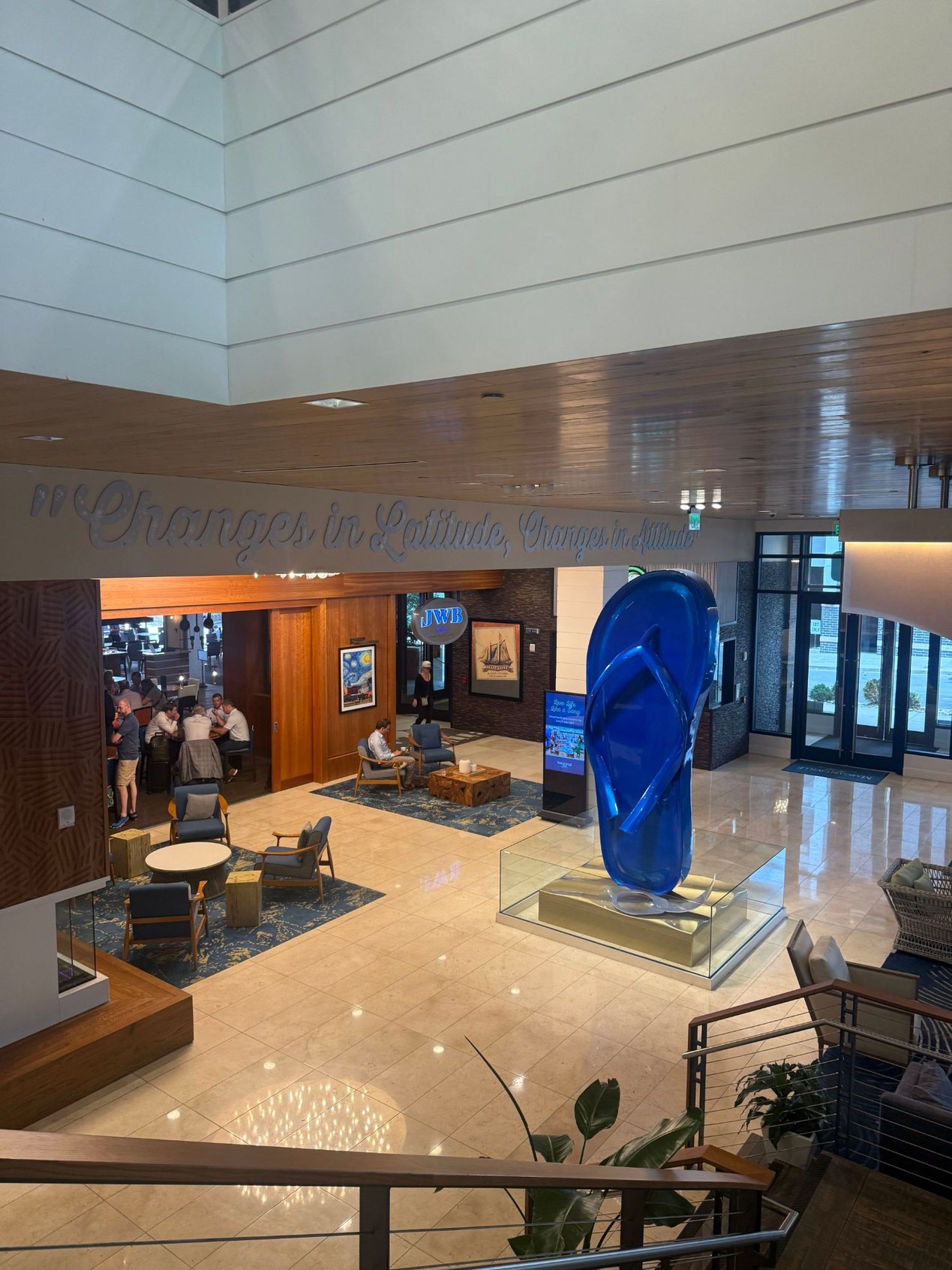 Hotel lobby with a giant blue flip-flop sculpture in a glass case | DSO Tech Summit and The Paubox Table in Nashville