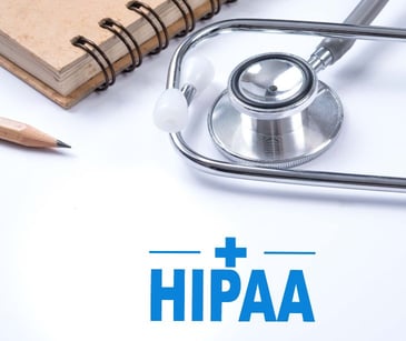HIPAA text with notepad and stethoscope