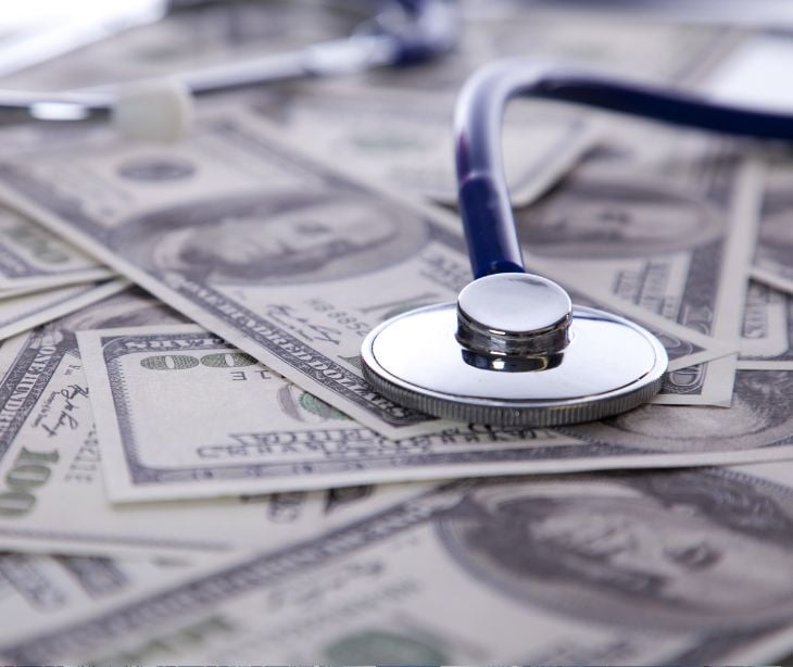 money bills with stethoscope