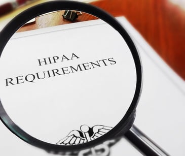 HIPAA paperwork under a magnifying glass