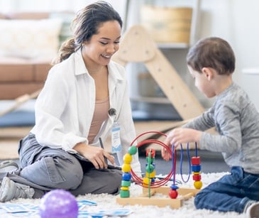 occupational therapist practicing with child patient
