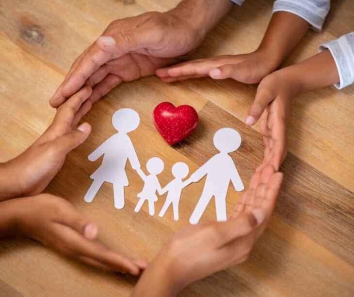 hands around family cutouts