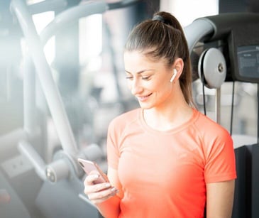 woman on phone at gym