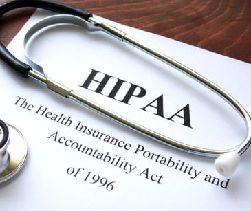 HIPAA paperwork with stethoscope on desk