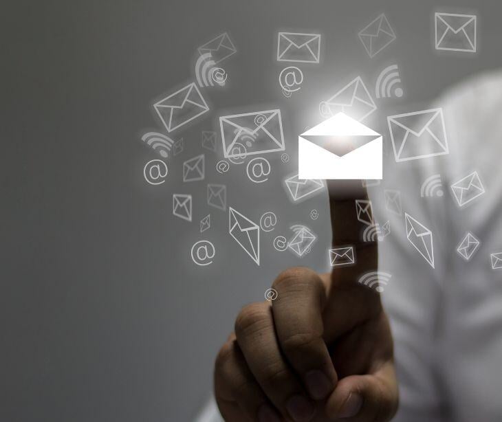 finger on floating email icons