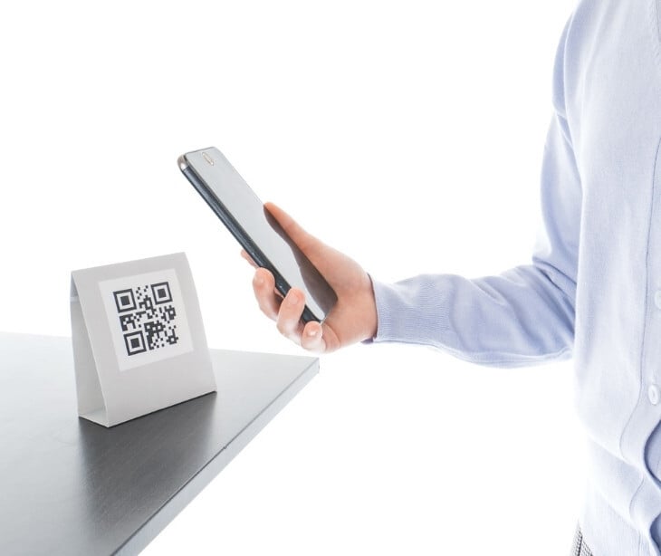 Image of someone scanning a QR code with their phone. 