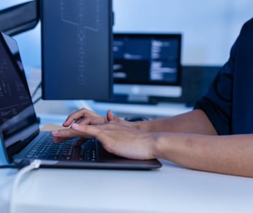 Image of someone typing into a computer. 