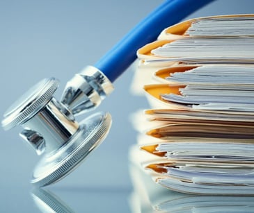 stethoscope on a stack of paperwork