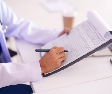 Image of a clipboard with a doctor's notes. 