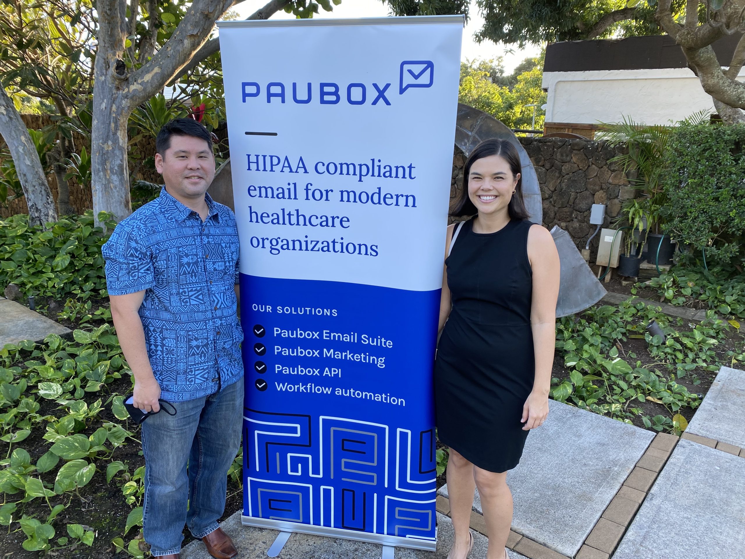 Paubox social mixer - Pacific Club - Two people posing near Paubox pop up banner