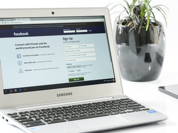 laptop with Facebook page open