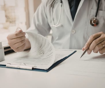 Image of healthcare professional looking at health records. 