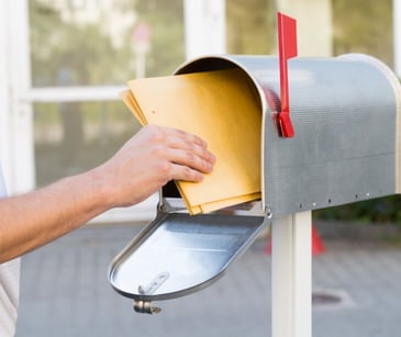 Image of someone dropping off mail. 