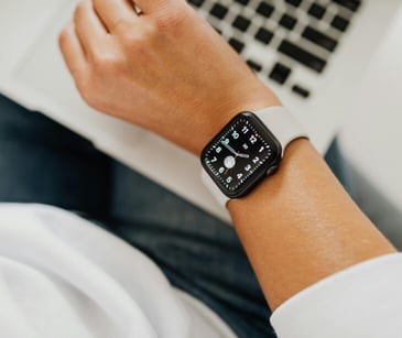 Image of someone with a smart watch working on a computer. 