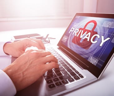 hands on laptop with privacy on screen