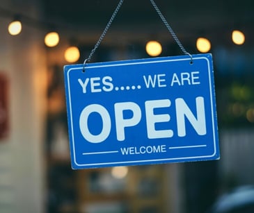 Image of a sign outside of a door that reads 