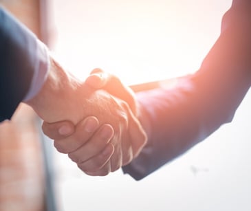 Image of two people shaking hands. 