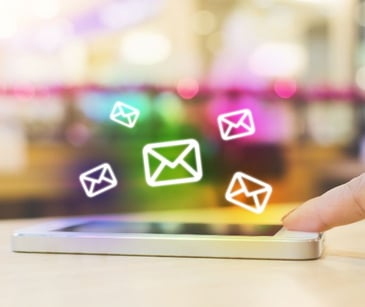 email icons floating over a smartphone