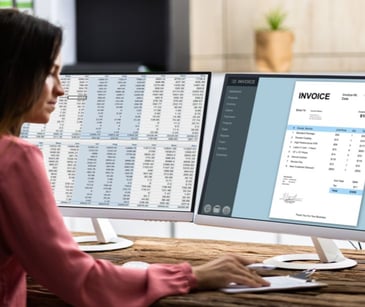 woman at computer with accounting software on screen