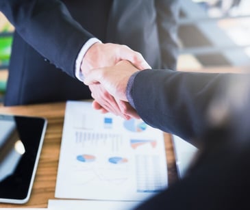 Image of two people shaking hands. 