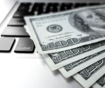money bills on a computer keyboard