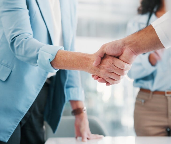 Image of two people shaking hands. 