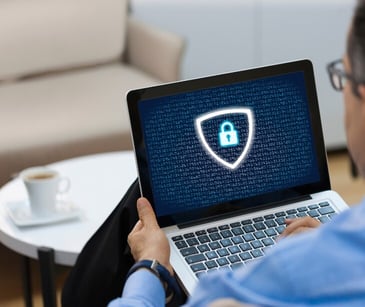 Image of a person on a computer with a lock on it. 