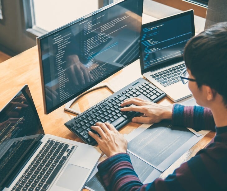 Image of someone typing on their computer. 