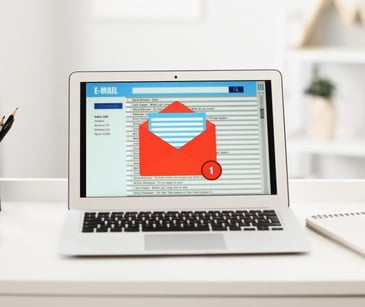 laptop with red email icon