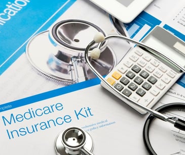 medicare paperwork with stethoscope and calculator