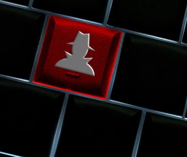 red key on keyboard with mysterious figure