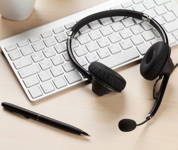 Image of a headset on a keyboard. 