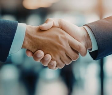 Image of two people shaking hands. 