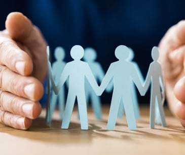 Image of paper cut outs of individuals. 