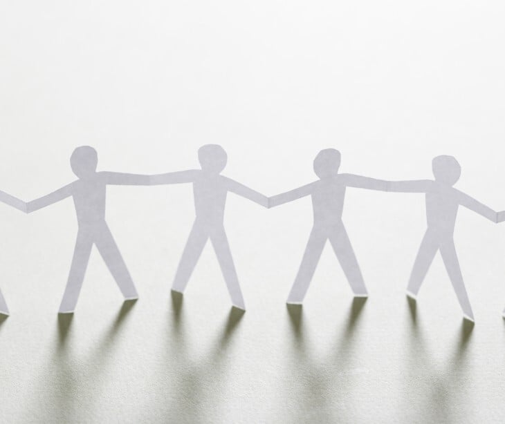 Image of paper cut-outs of people. 