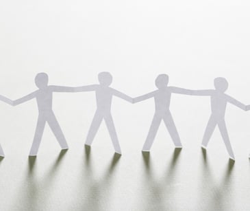 Image of paper cut-outs of people. 